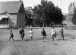 Children running near the Bluff stone co-op. Can you identify them? Charles Goodman Photo